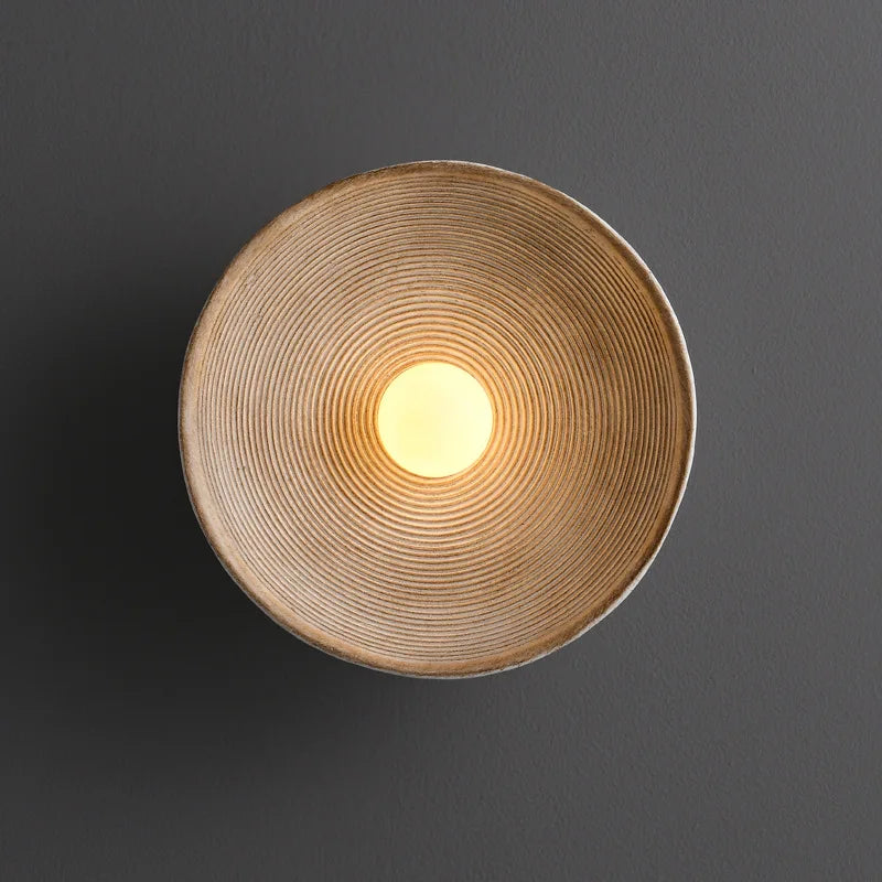 Wabi Sabi round wall lamp with frosted glass shade in a living room