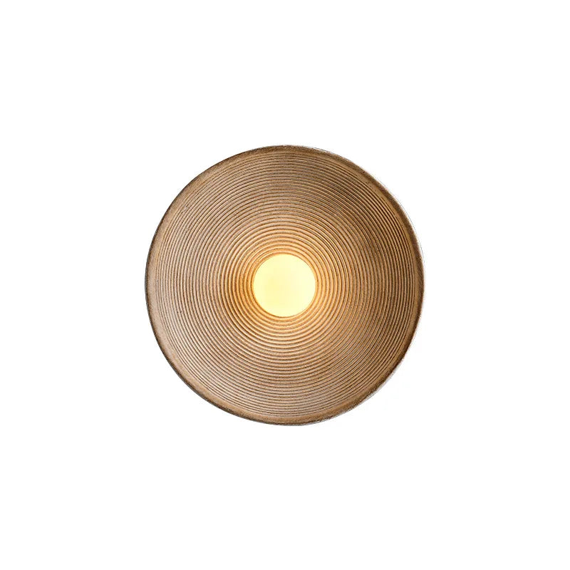 Minimalist round wall lamp providing soft lighting in a corridor