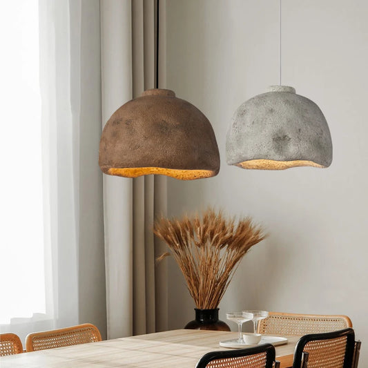 Wabi-Sabi Inspired LED Pendant Light in bronze clay hanging in a dining room